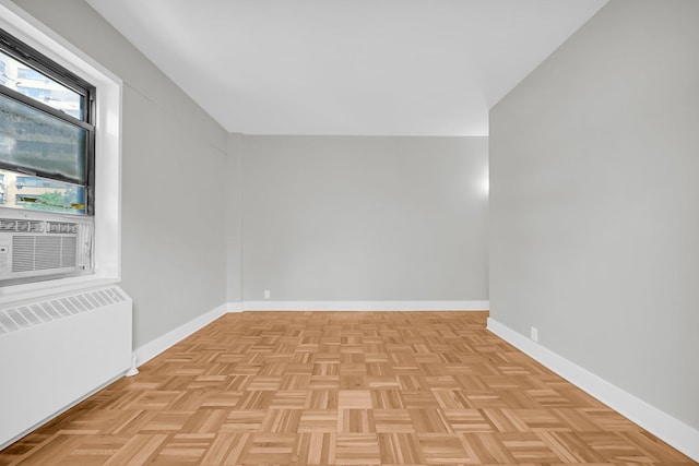 bonus room featuring radiator, light parquet floors, and cooling unit