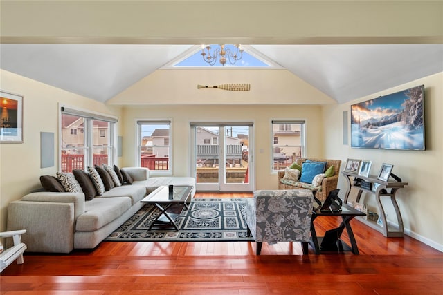 living room featuring a notable chandelier, vaulted ceiling, and wood-type flooring