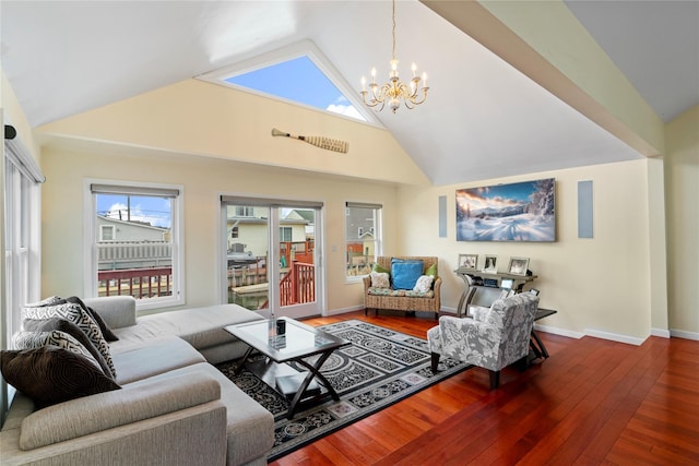 living room with high vaulted ceiling, hardwood / wood-style floors, and a chandelier