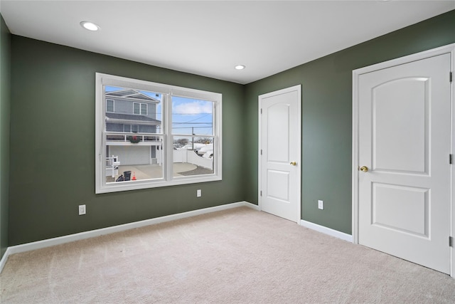 unfurnished bedroom featuring light carpet