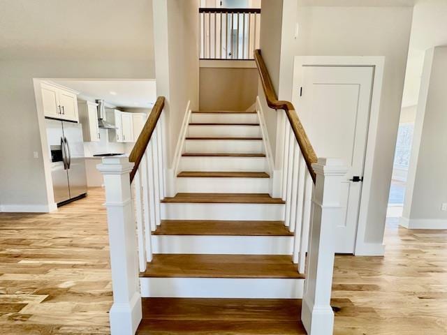 stairs with hardwood / wood-style flooring