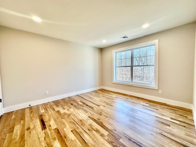 spare room with hardwood / wood-style flooring