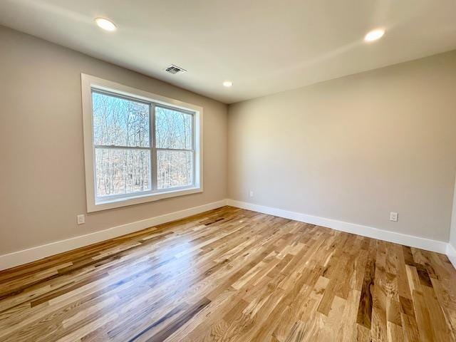 unfurnished room featuring light hardwood / wood-style floors