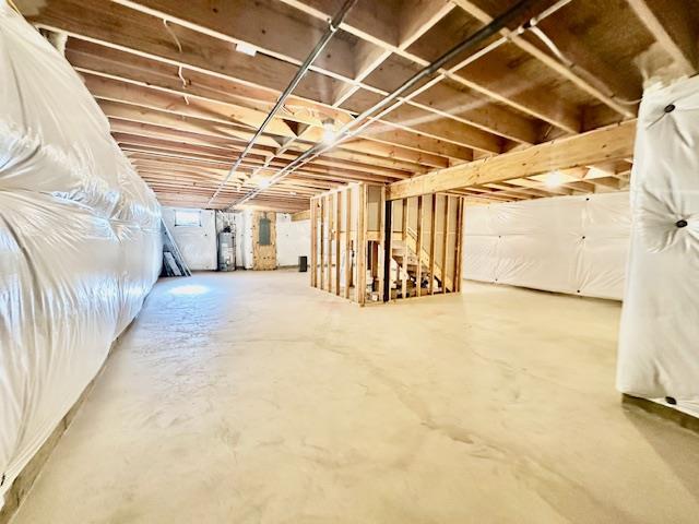 basement featuring gas water heater and electric panel