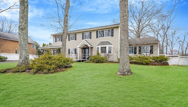 colonial-style house with a front lawn