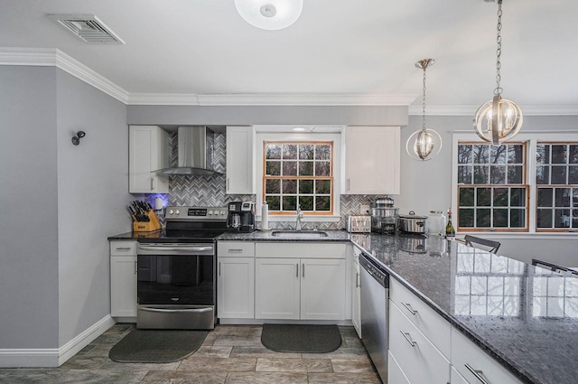 kitchen with white cabinetry, sink, wall chimney exhaust hood, stainless steel appliances, and dark stone counters