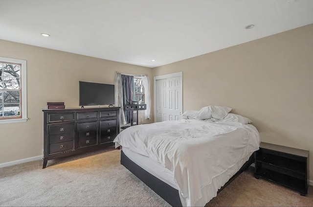 bedroom featuring light colored carpet and a closet