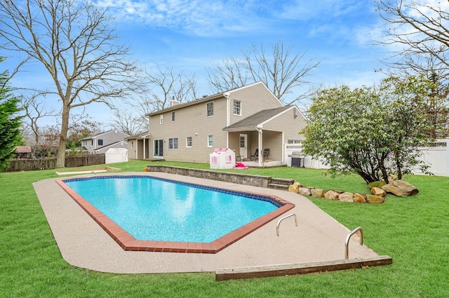 view of pool featuring a lawn and a patio area