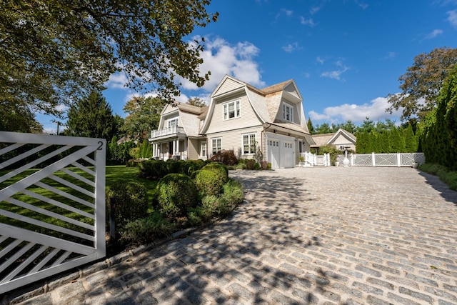 view of front of home with a balcony and a garage