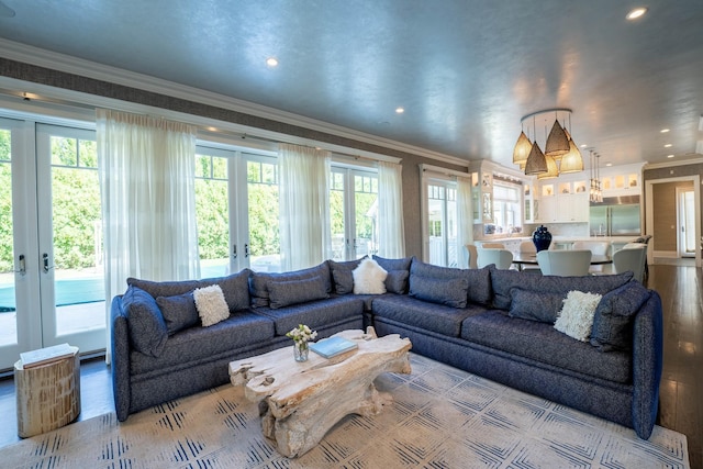 living room with light hardwood / wood-style floors, crown molding, and french doors