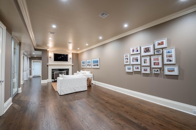 living room featuring dark hardwood / wood-style flooring and ornamental molding