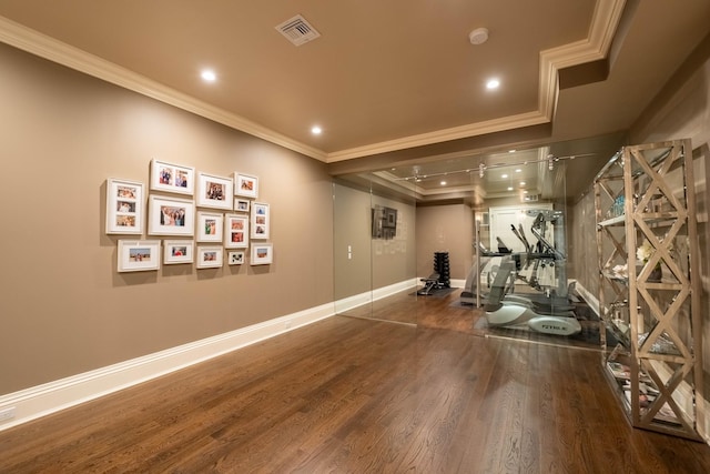 exercise area with dark hardwood / wood-style flooring and ornamental molding