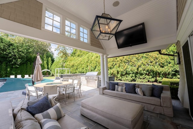 view of patio featuring an outdoor hangout area, exterior kitchen, and a grill