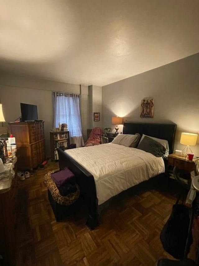 bedroom with dark parquet flooring