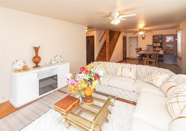 living room with ceiling fan and light wood-type flooring