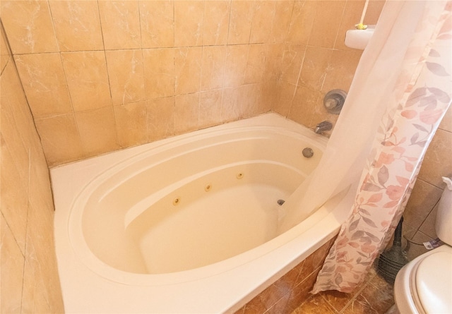 bathroom with tile patterned floors, toilet, and shower / bath combination with curtain