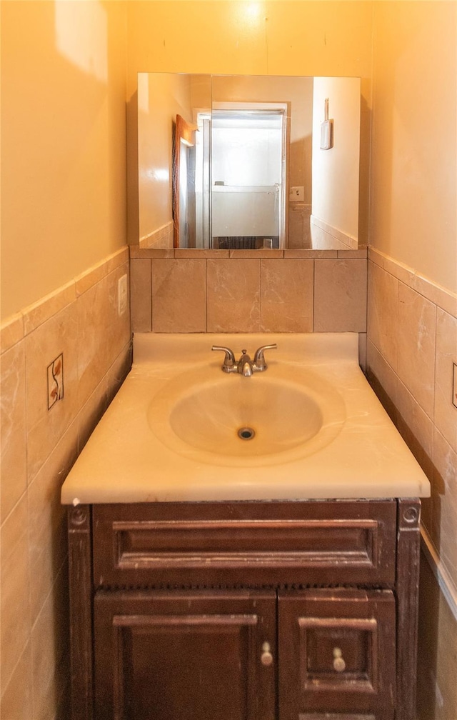 bathroom with tile walls and vanity