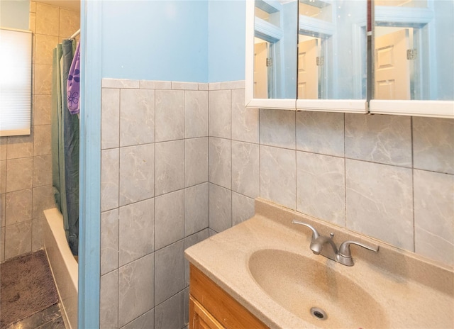 bathroom featuring tile walls and vanity