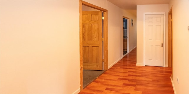 corridor with light wood-type flooring