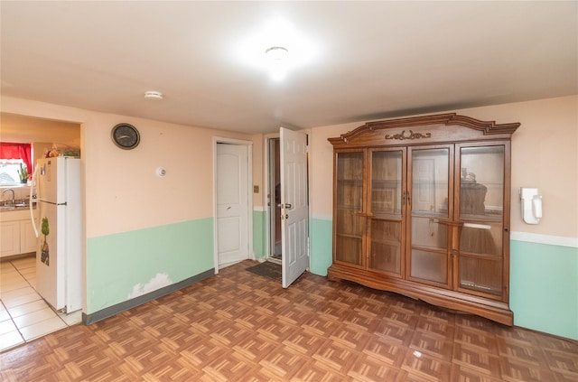 spare room featuring sink and parquet floors