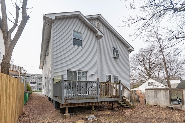 back of house with a deck