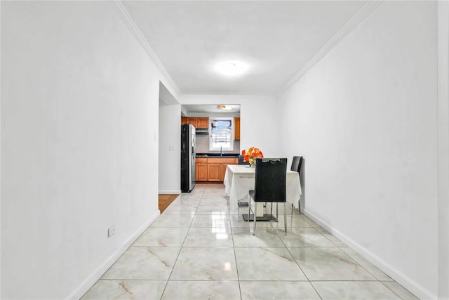 hall featuring ornamental molding and sink