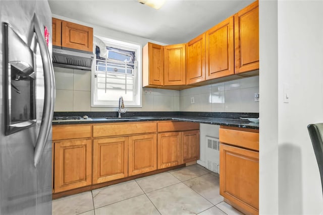 kitchen with sink, light tile patterned floors, gas stovetop, stainless steel refrigerator with ice dispenser, and exhaust hood