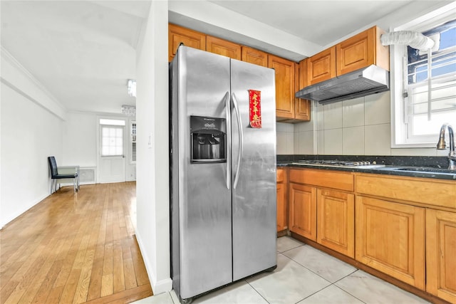 kitchen with stainless steel appliances, sink, a wealth of natural light, and ventilation hood