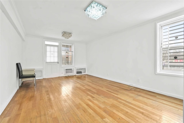 unfurnished room with light wood-type flooring and ornamental molding