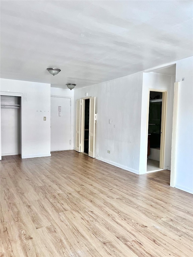 spare room featuring light hardwood / wood-style floors