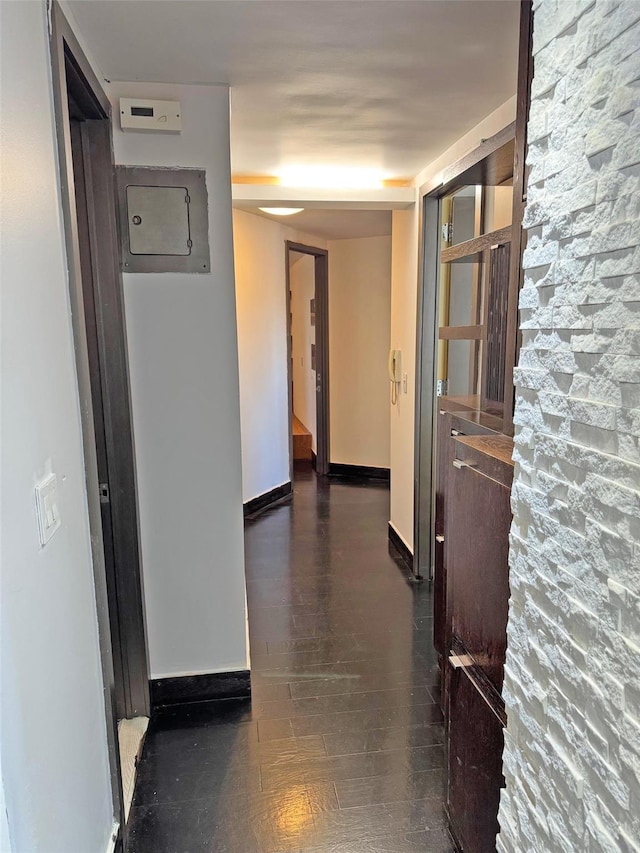 corridor with dark hardwood / wood-style floors