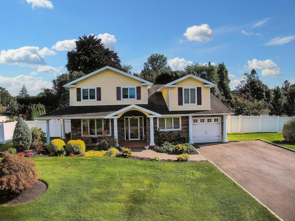 view of front of property with a porch and a front lawn