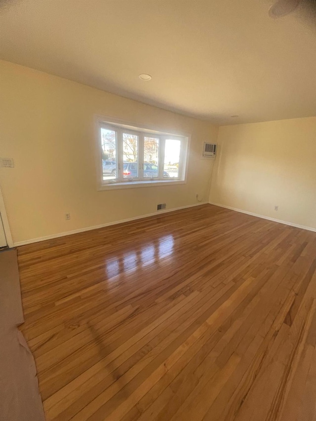 empty room with hardwood / wood-style flooring