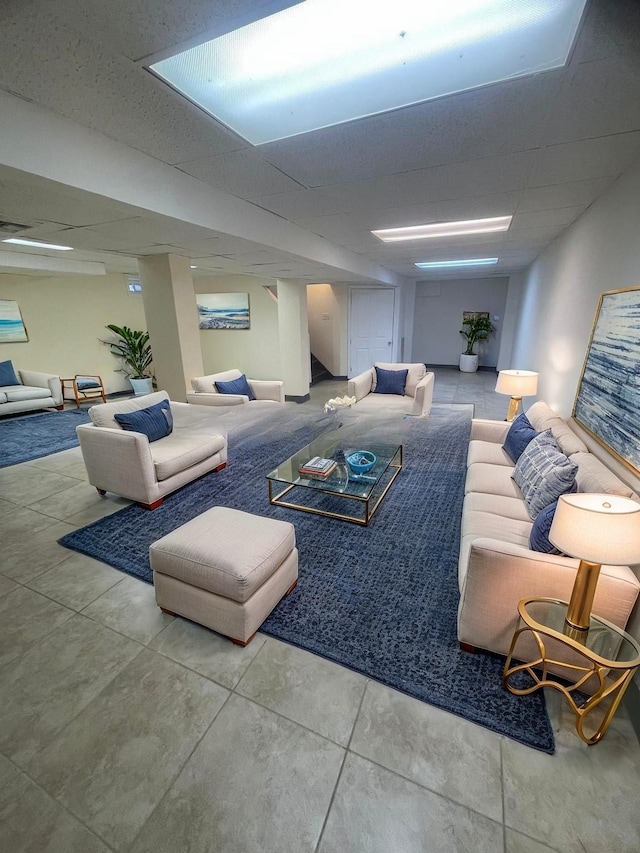 living room featuring a paneled ceiling