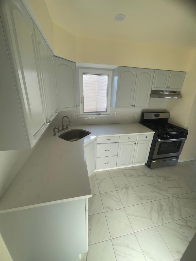 kitchen with sink, white cabinetry, and stainless steel gas range