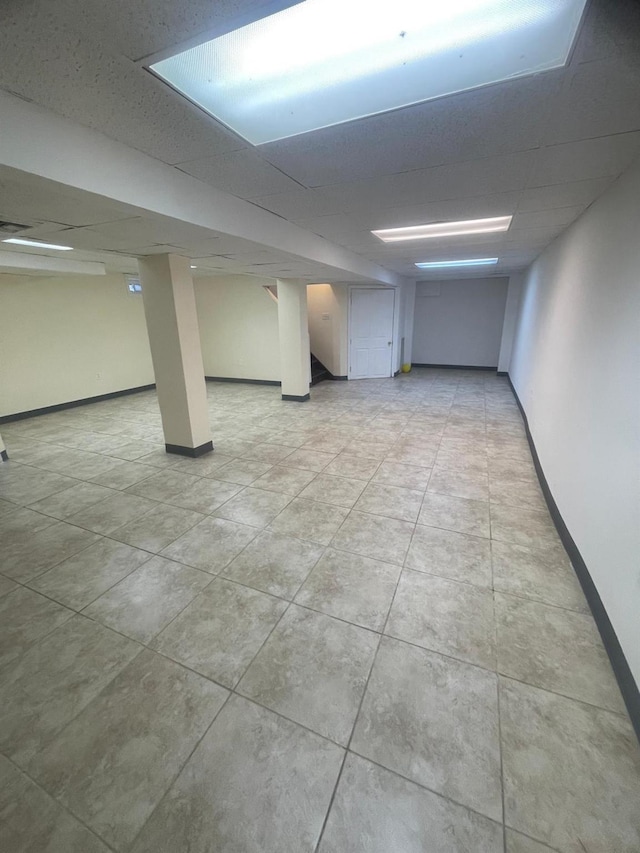 basement featuring a drop ceiling