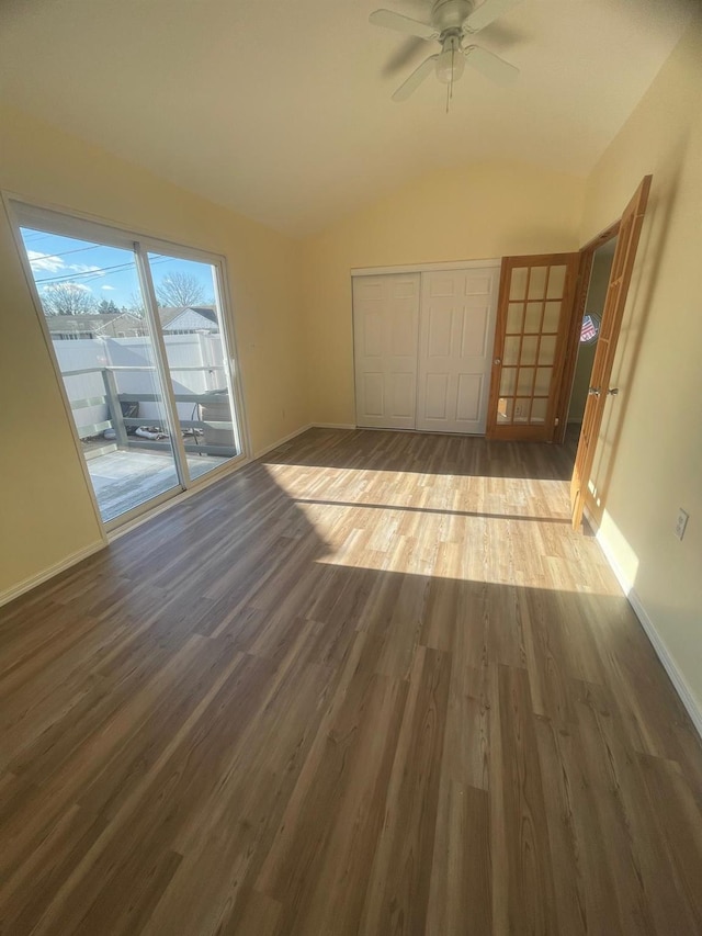 unfurnished bedroom with hardwood / wood-style floors, ceiling fan, access to exterior, and lofted ceiling