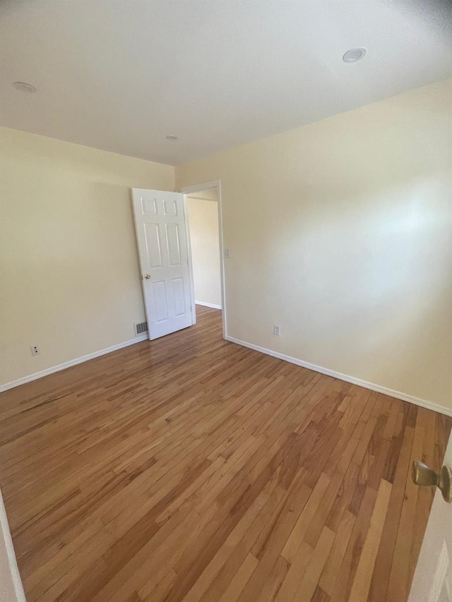 spare room featuring hardwood / wood-style floors