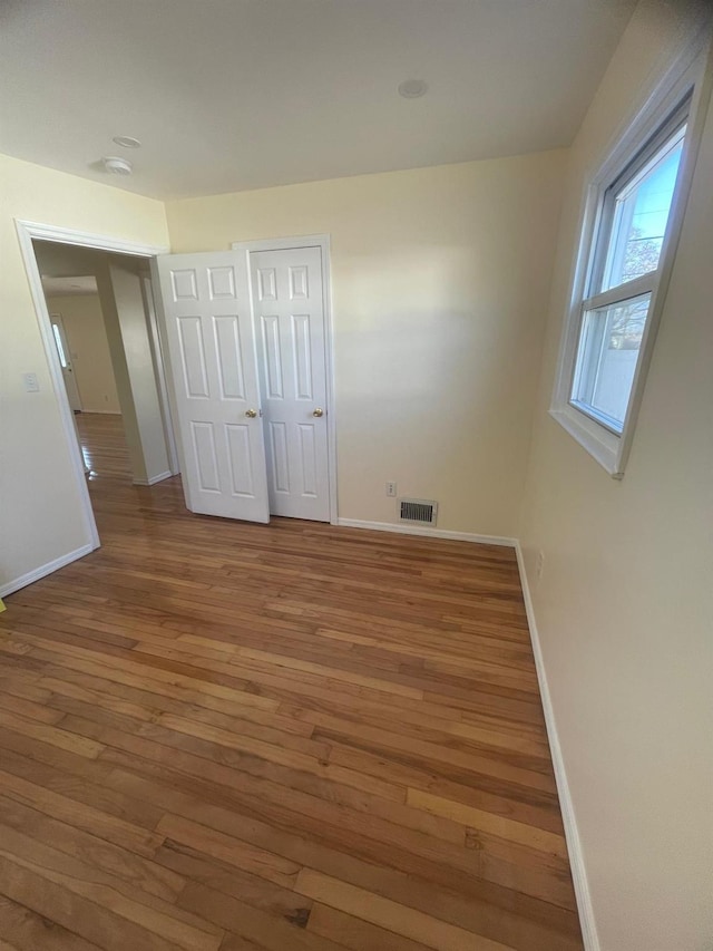 unfurnished bedroom featuring hardwood / wood-style flooring