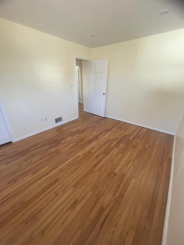 unfurnished room featuring hardwood / wood-style floors