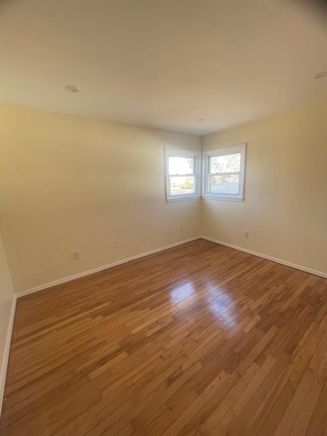 spare room with hardwood / wood-style flooring