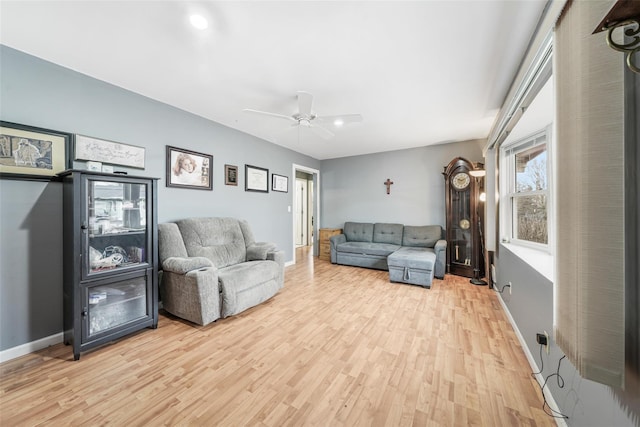 living room with ceiling fan and light wood-type flooring