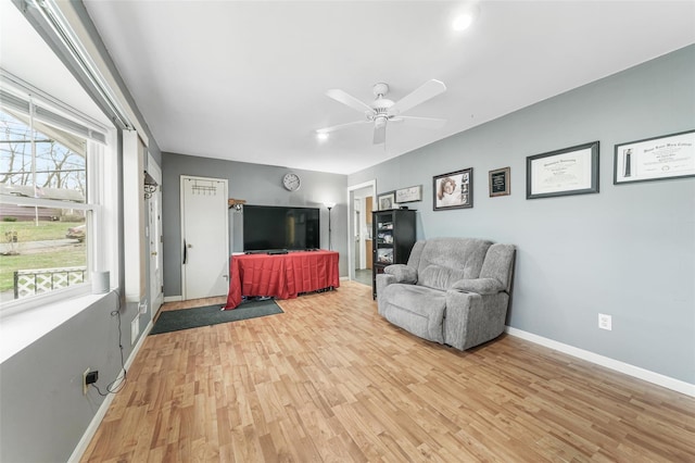 living room with hardwood / wood-style floors and ceiling fan