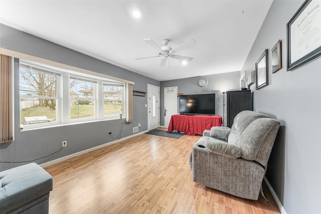 living room featuring ceiling fan and wood-type flooring