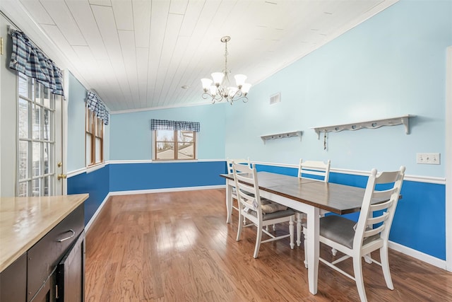 dining area featuring ornamental molding, wood ceiling, an inviting chandelier, light hardwood / wood-style floors, and lofted ceiling