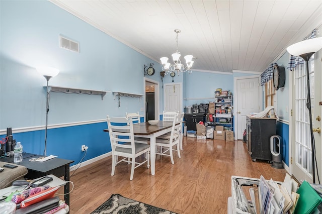 dining room with wood ceiling, vaulted ceiling, crown molding, a chandelier, and hardwood / wood-style floors