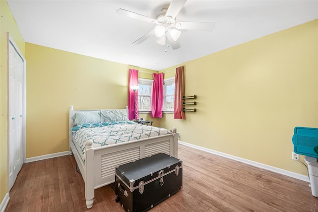 bedroom featuring hardwood / wood-style floors, ceiling fan, and a closet