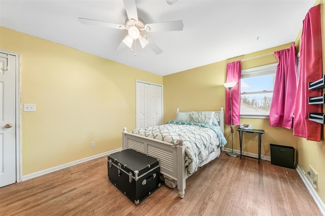 bedroom with hardwood / wood-style floors, ceiling fan, and a closet