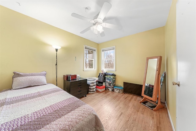 bedroom with ceiling fan and light hardwood / wood-style floors