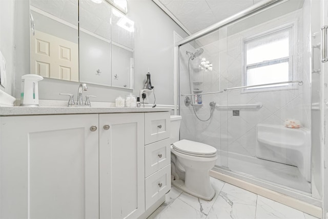 bathroom featuring vanity, a shower with shower door, and toilet